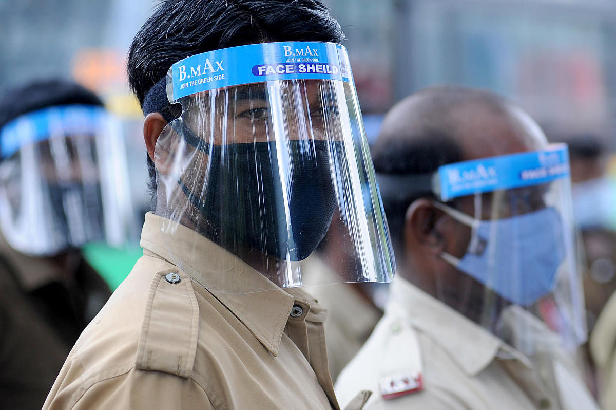 BMTC staffers wear face shields at the depot in Shantinagar. DH Photo/Pushkar V