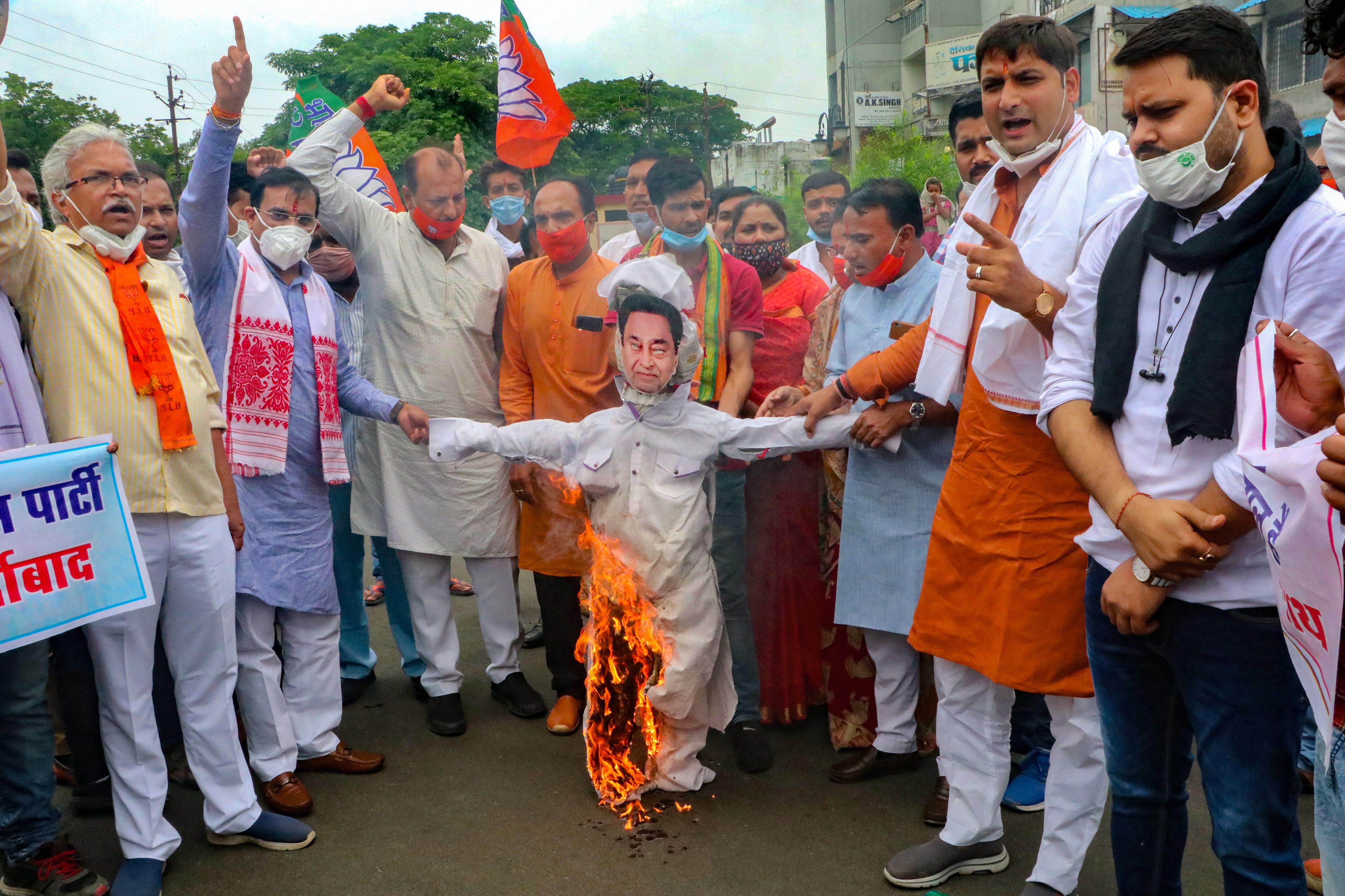 BJP State President VD Sharma along with party workers burn an effigy of the former chief minister and Congress leader Kamal Nath. Credits: PTI Photo