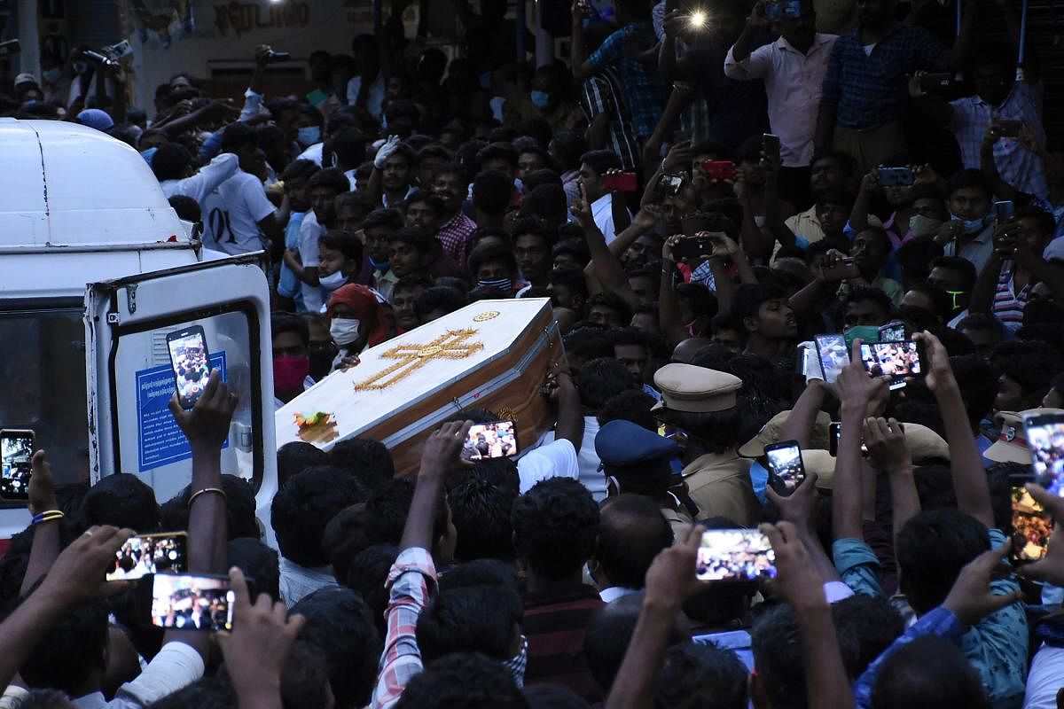 In this picture taken on June 26, 2020, residents gather as they carry the coffin of Jayaraj, 58, and son Bennicks Immanuel, 31, allegedly tortured at the hands of police in Sathankulam, Thoothukudi district in the Indian state of Tamil Nadu. - The deaths