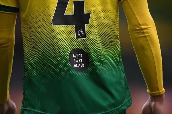 A Black Lives matter logo is seen on the back of Norwich City's English midfielder Ben Godfrey's shirt during the English FA Cup quarter-final football match between Norwich City and Manchester United at Carrow Road in Norwich, eastern England on June 27, 2020. Credit: AFP Photo