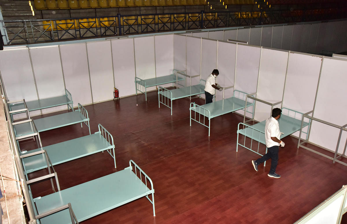 Beds being readied at the Koramangala Indoor Stadium, which is a Covid Care Centre. DH photo/Irshad Mahammad