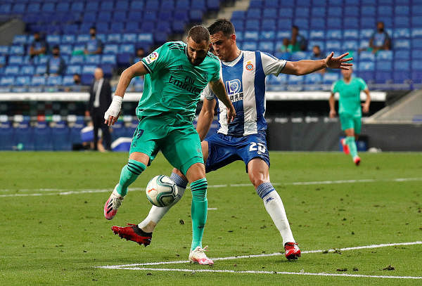 Bernardo Espinosa in action with Real Madrid's Karim Benzema, as play resumes behind closed doors following the outbreak of the coronavirus disease. Credit: Reuters Photo