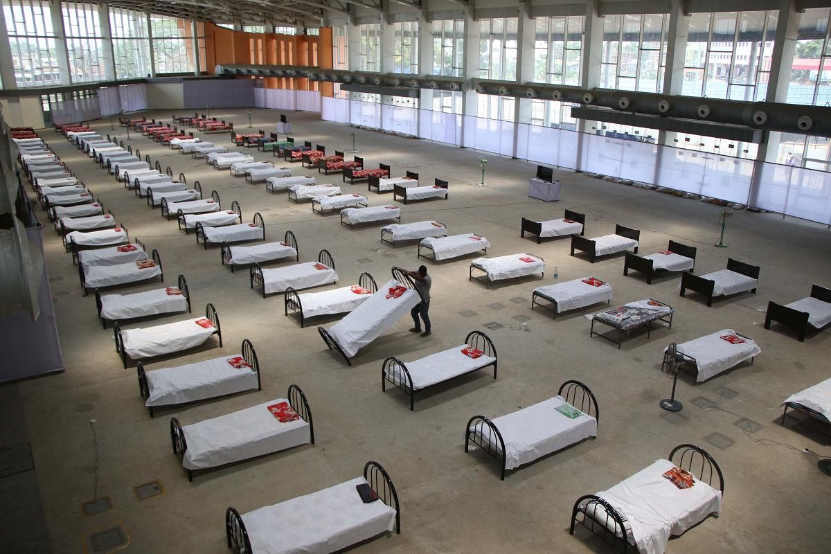 A worker arranges beds at quarantine centre set up in the Hapania International Fair Complex during a nationwide lockdown imposed as a preventive measure against the COVID-19 coronavirus, on the outskirts of Agartala. AFP