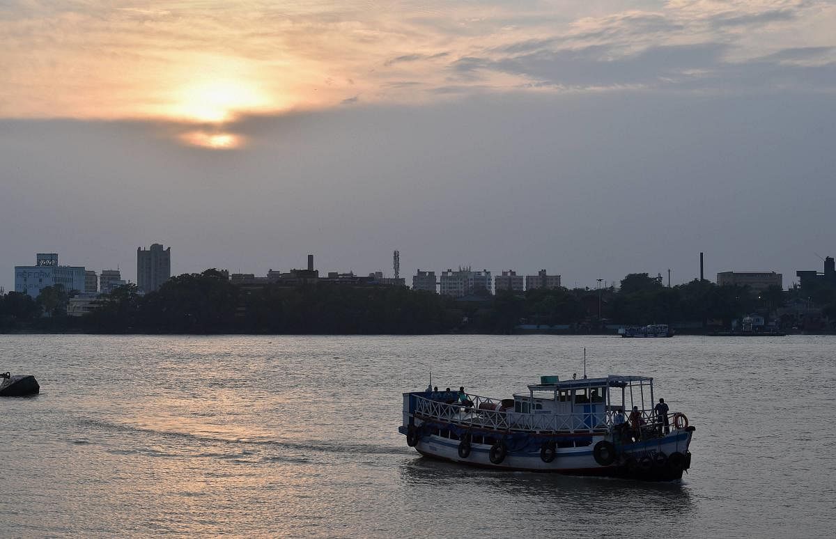 A ferry service carrying passengers crosses the Ganga river during sunset, in Kolkata. Credit: PTI