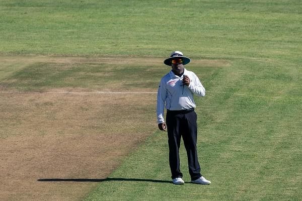 In this file photo taken on January 21, 2020 umpire Nitin Menon awaits Langton Rusere, the third umpire's decision on the dismissal of Sri Lanka's Dinesh Chandimal during the third day of the first Test cricket match between Zimbabwe and Sri Lanka at the Harare Sports Club in Harare. Credit: AFP Photo