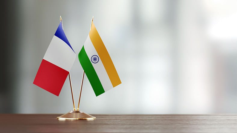 Indian and French flag pair on desk. (iStock)