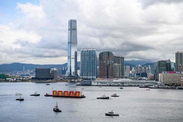 A barge (C) with banners that read “Celebrate the National Security Law” sails in Victoria Harbour on the 23rd anniversary of Hong Kong’s handover from Britain in Hong Kong on July 1, 2020. Credit: AFP Photo