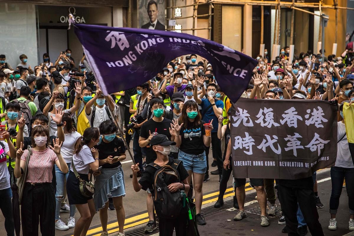 Protesters chant slogans during a rally against a new national security law in Hong Kong (AFP Photo)