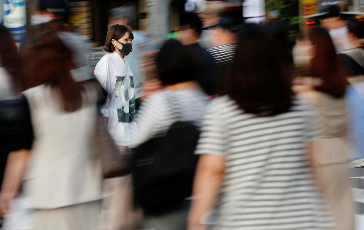 A woman wearing a protective mask makes her way amid the coronavirus disease (COVID-19) outbreak at a downtown in Tokyo, Japan June 29, 2020. Credit/Reuters Photo