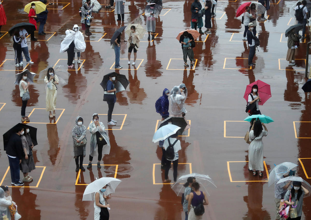 Visitors practice social distancing while waiting to enter the park in the poor weather during the reopening of Tokyo Disneyland along with Tokyo DisneySea, which closed for months due to the coronavirus disease (COVID-19) outbreak. Representative image from Reuters