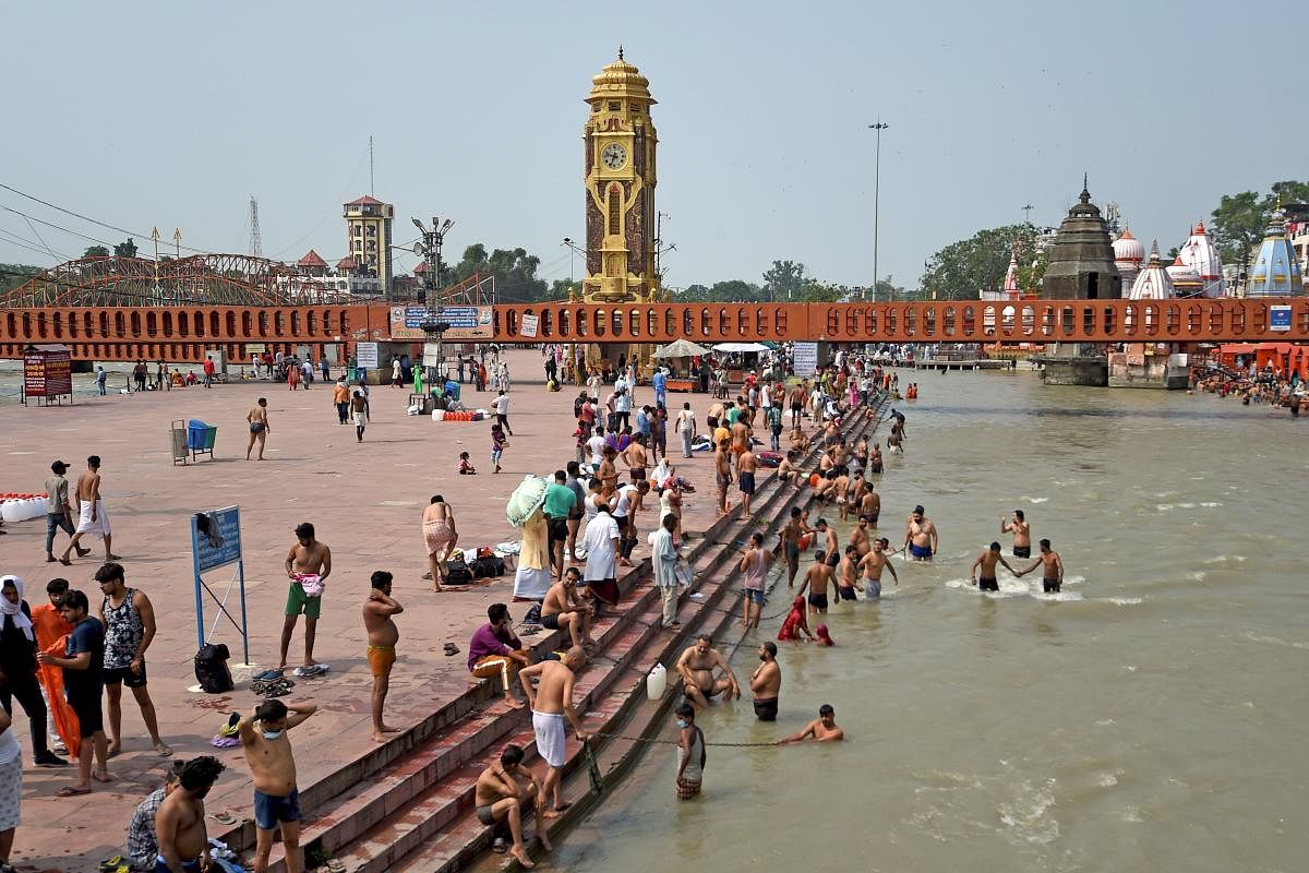 Devotees take a dip at Har Ki Pauri ghat on the banks of the river Ganges (AFP  Photo)
