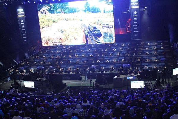 Fans watch as 80 players simultaneously fight for survival in an eSports match of upstart computer game “PlayUnknown's Battlegrounds” at an Intel Extreme Masters tournament in the Oracle Arena in Oakland, California on November 18, 2017. Credit: AFP Photo