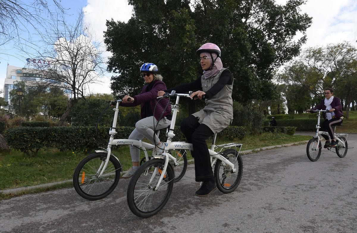 Tunisian women learn to cycle at the Japanese garden in central Tunis which is every Sunday transformed into an impromptu bicycle academy for dozens of novice cyclistson, on March 8, 2020. Credit/AFP Photo