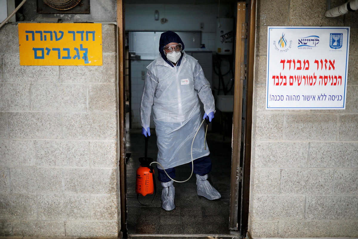 Yakov Kurtz, who works for Chevra Kadisha, the main group overseeing Jewish burials in Israel, disinfects a room at a special centre that prepares bodies of Jews who died from the coronavirus disease (COVID-19), in Tel Aviv. Credit/Reuters File Photo