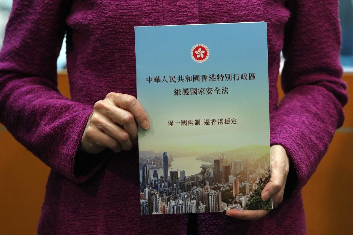 Hong Kong's Chief Executive Carrie Lam holds a copy of the new national security law during a press conference at the government headquarters in Hong Kong on July 1, 2020, on the 23rd anniversary of the city's handover from Britain to China. Credit/AFP Photo
