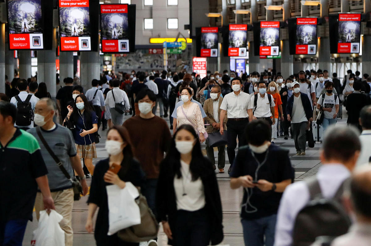 Passengers wearing protective face masks walk as the spread of the coronavirus disease (COVID-19) continues, at a station in Tokyo, Japan June 24, 2020. Credit/Reuters Photo