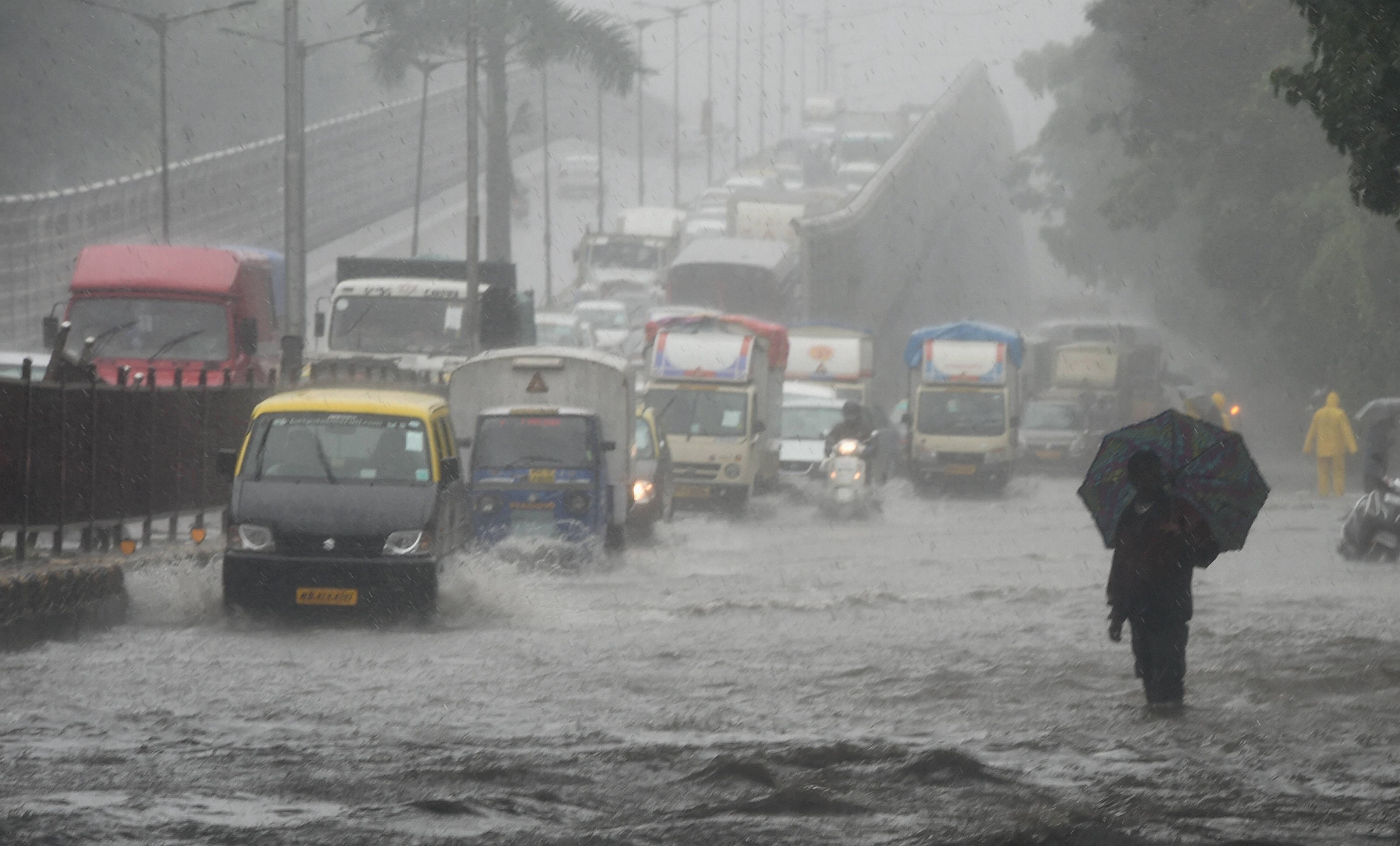 Vehicles ply on a waterlogged street during rain, at King's circle in Mumbai, Friday, July 3, 2020. (PTI Photo)