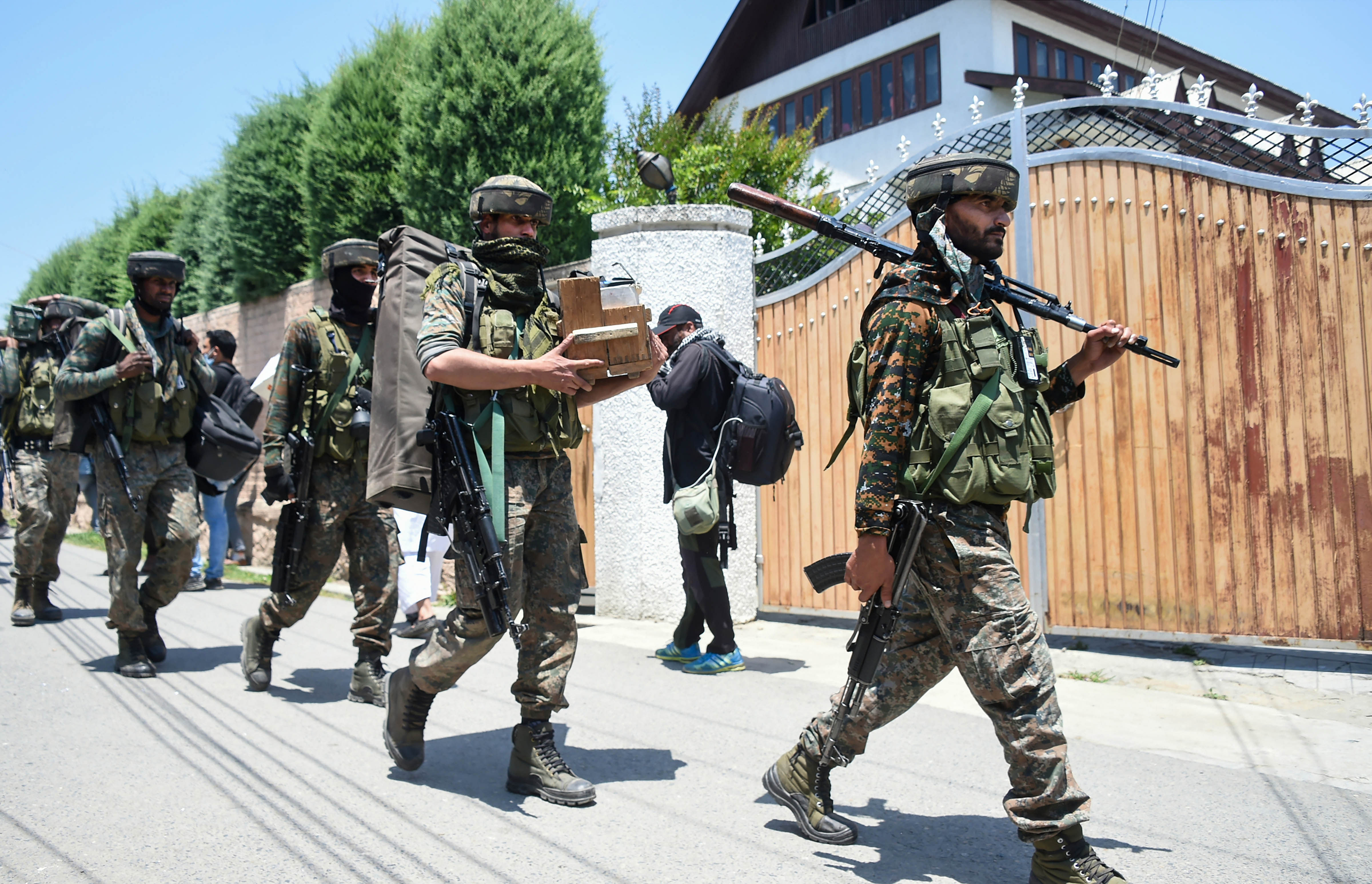 Security personnel leave after the encounter with militants ended at Zoonimar area of Srinagar. Credits: PTI Photo