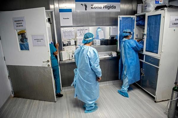 Health professionals prepare to enter the Intensive Care Unit of the Alberto Sabogal Sologuren Hospital, in Lima, on July 02, 2020, amid the new coronavirus pandemic. Credit: AFP Photo