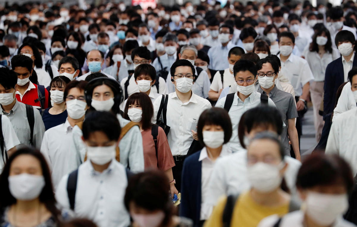 People wearing protective masks amid the coronavirus disease (COVID-19) outbreak, make their way during rush hour at a railway station in Tokyo. Credit/Reuters Photo