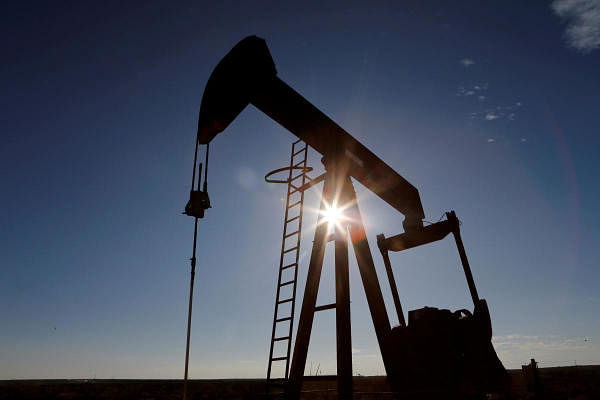 The sun is seen behind a crude oil pump jack in the Permian Basin in Loving County. Credits: Reuters Photo