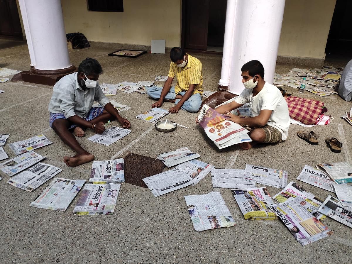 Inmates of the rehabilitation centre at Nanjaraja Bahadur Choultry in Mysuru are engaged in the preparation of paper covers. DH PHOTO
