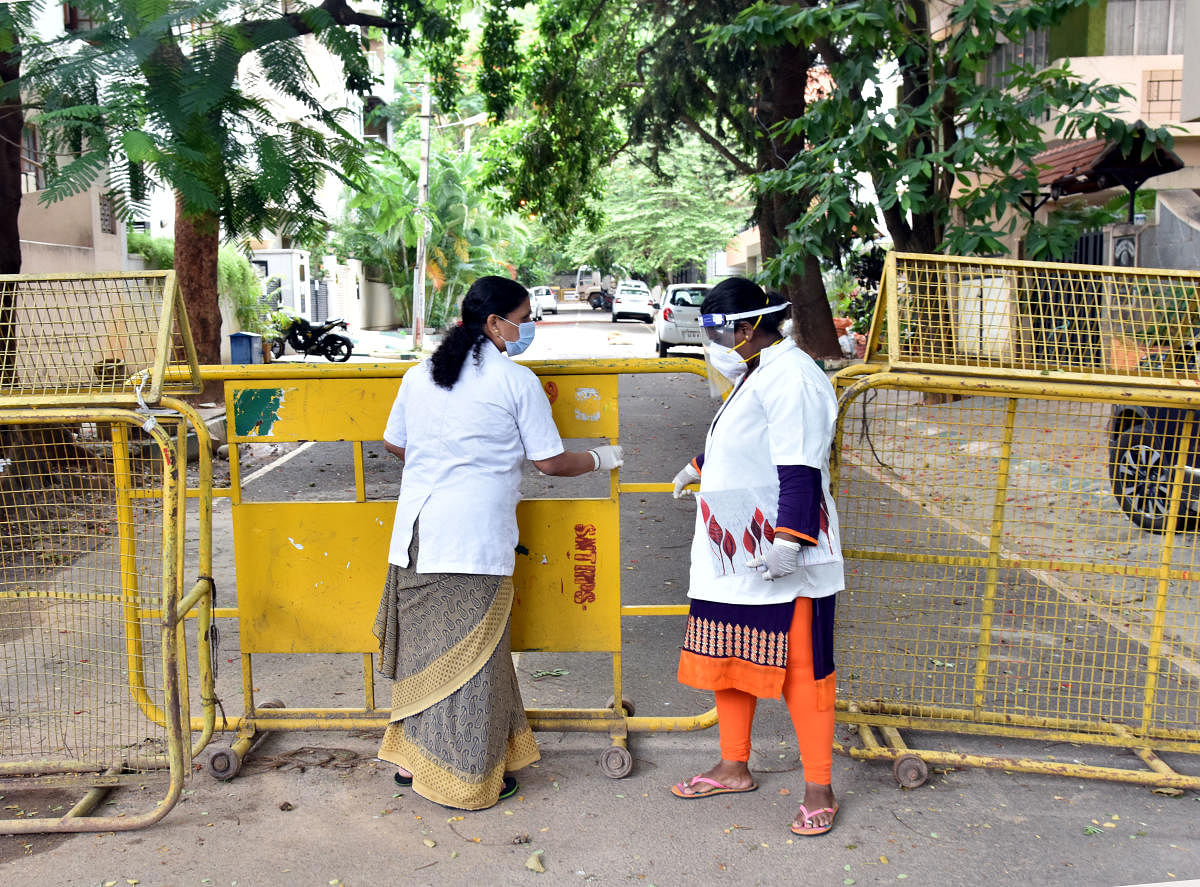 Healthcare workers on Thursday visit Sadashivanagar that has been sealed down. DH photo/Janardhan B K