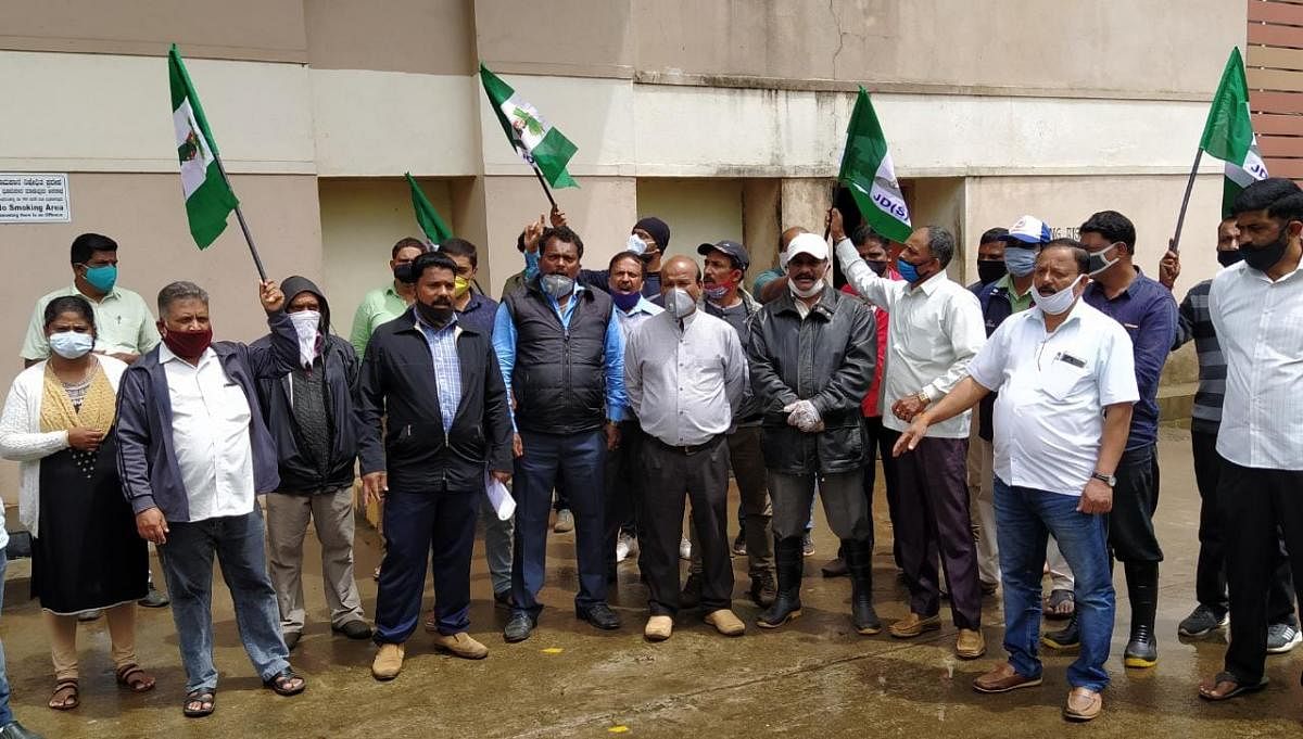 JD(S) workers stage a protest in front of the DC's office on Friday.