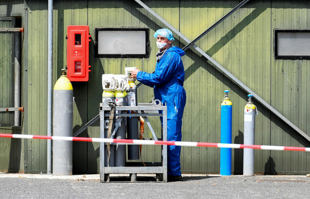 A worker in protective gear is seen at a farm where minks were gassed, as the country continues a cull to prevent the animals from possibly infecting humans with the coronavirus disease. Reuters