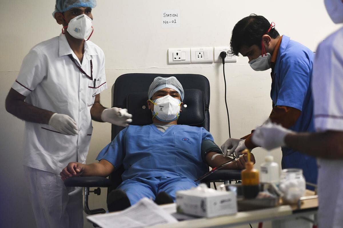 A plasma donor (C) is seen at the newly inaugurated plasma bank of the Institute of Liver and Biliary Sciences (ILBS) donating plasma for the treatment of patients suffering from the Covid-19, in New Delhi on July 2, 2020.  Credit/AFP Photo