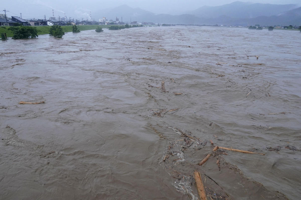 Rising water caused by a heavy rain is seen along Kuma river in Yatsushiro, Japan. Reuters/Kyodo