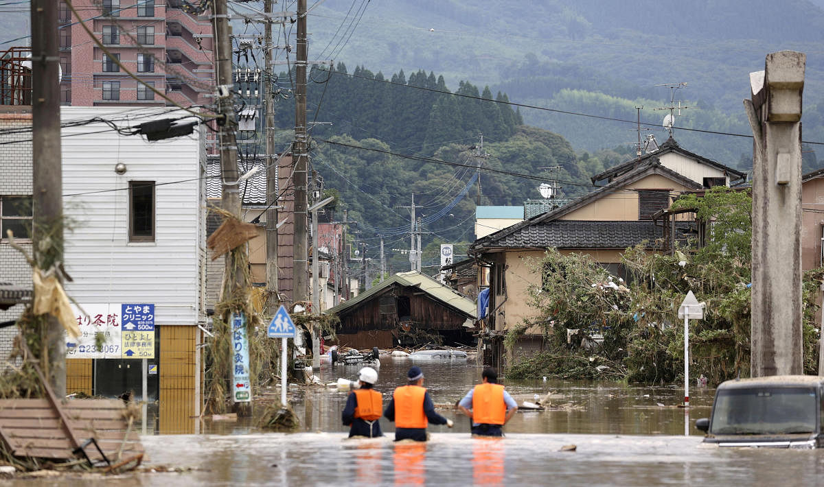 Police officers search for residents stuck in a flooded area caused by a heavy rain along Kuma River in Hitoyoshi, Kumamoto prefecture, southern Japan. Credit: Kyodo/via Reuters