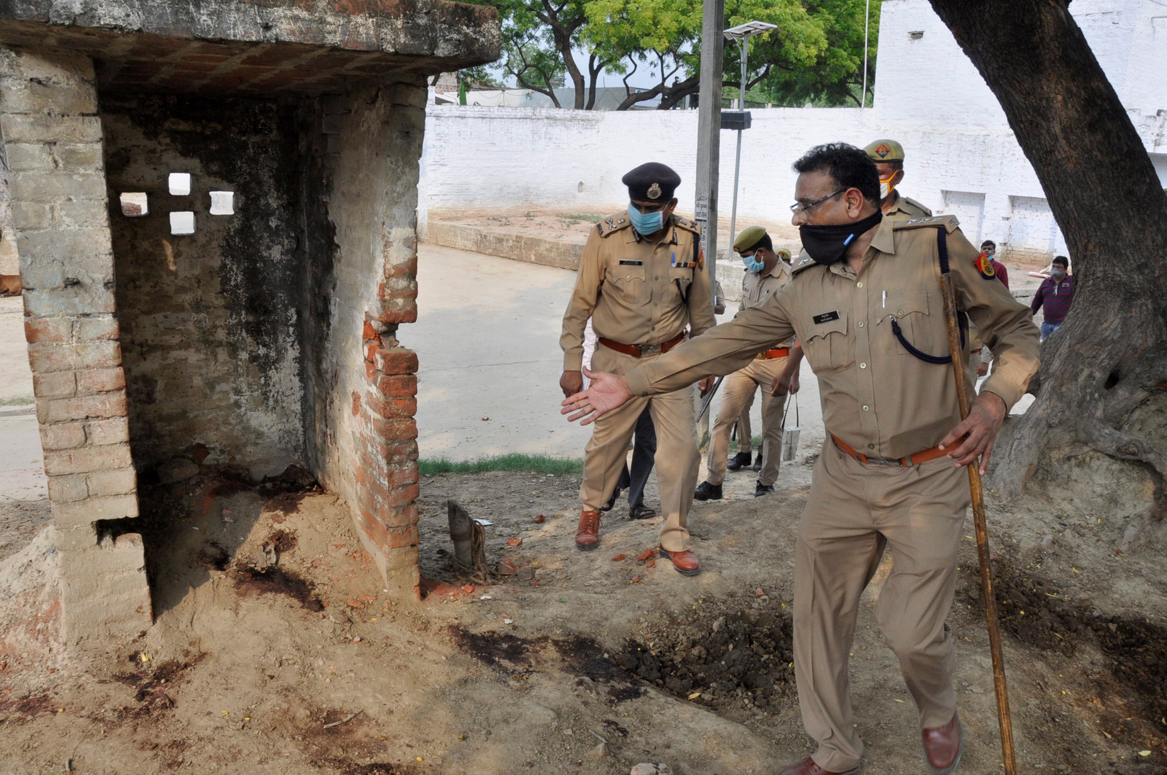 ADG Law and Order Prashant Kumar being shown a site during a visit to the Bikhru village after an encounter between the police and history sheeter Vikas Dubey and other criminals, under Chaubey Pur Police Station in Kanpur, Friday, July 3, 2020. At least 8 police personnel including a Deputy Superintendent of Police were killed in the encounter. (PTI Photo)