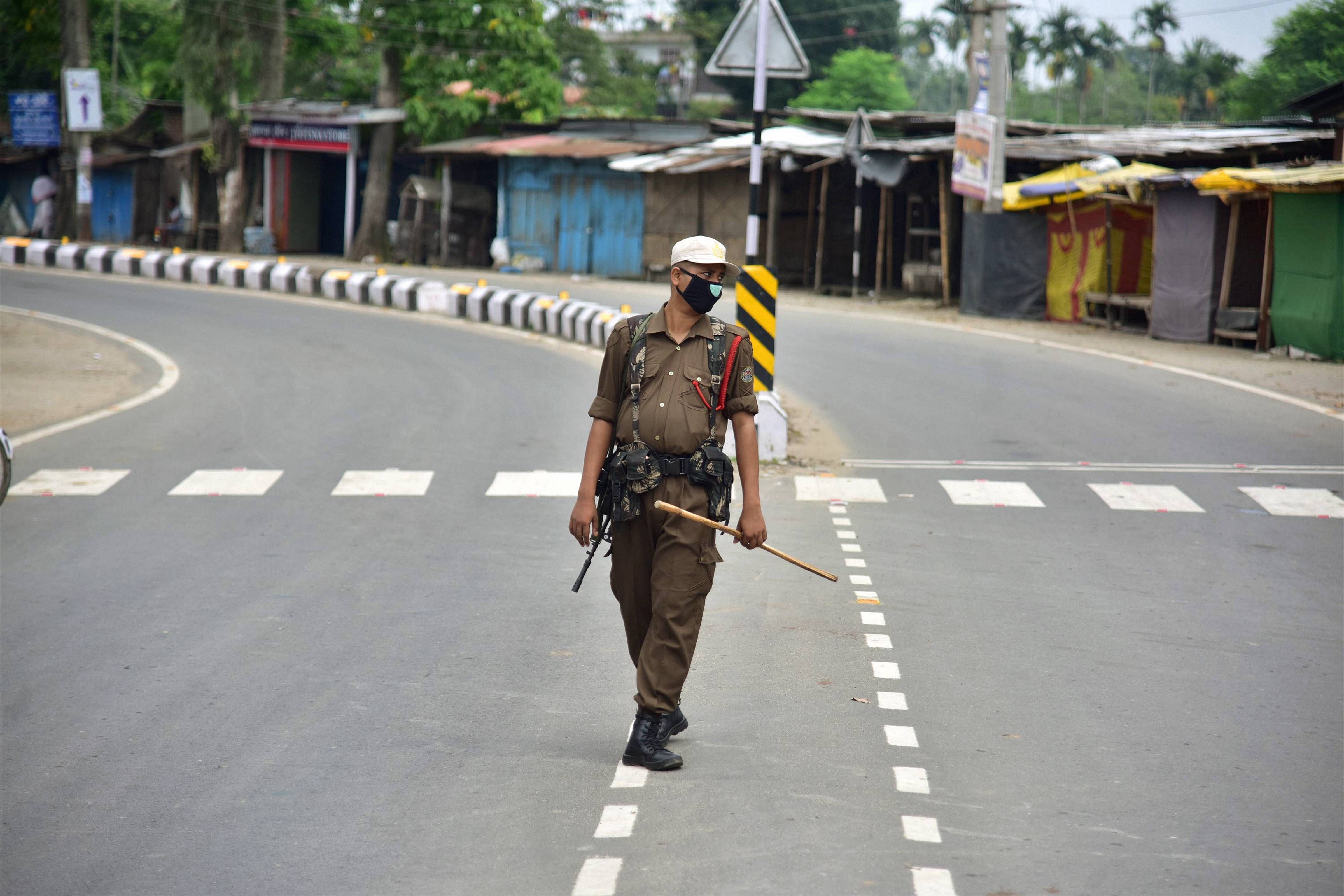 A security personnel stands guard during the strict lockdown imposed by the Assam Government to curb the spread of the novel coronavirus. Credit: PTI Photo