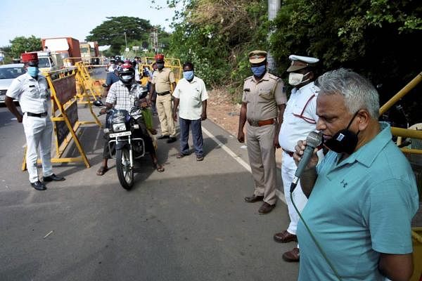 Puducherry Health Minister Malladi Krishna Rao along with police personnel and medics check commuters crossing a border due to surge in Covid-19 cases, in Puducherry, Saturday, June 20, 2020. Credit: PTI Photo