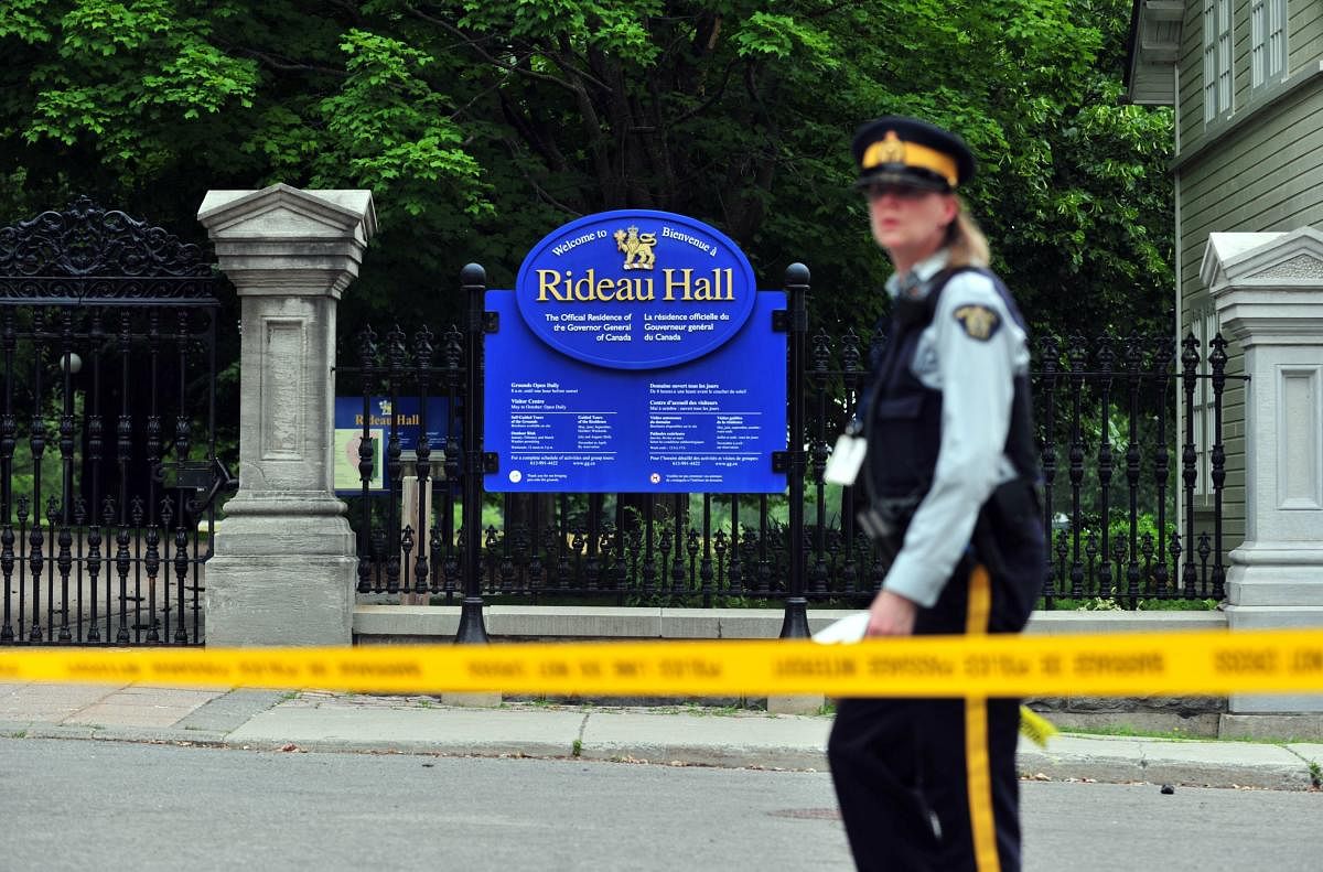 A Canadian police officer walks by Rideau Hall near the grounds of the Ottawa estate that is home to Prime Minister Justin Trudeau and the country's governor general on July 2, 2020 in Ottawa, Ontario. AFP