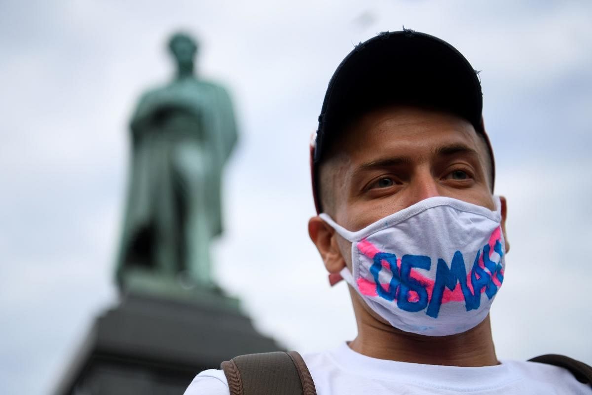 A man wearing a face mask decorated with a lettering reading "Deception" protests against amendments to the Constitution of Russia (AFP Photo)