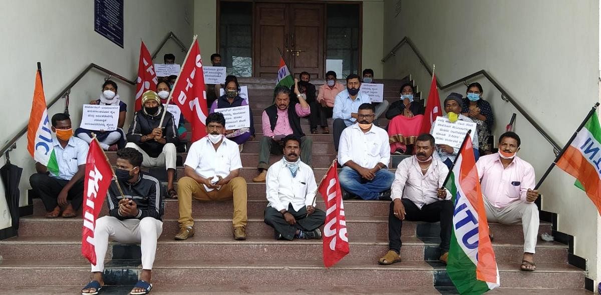 Joint Action Committee of Trade Unions stages a protest in front of the DC's office in Madikeri.