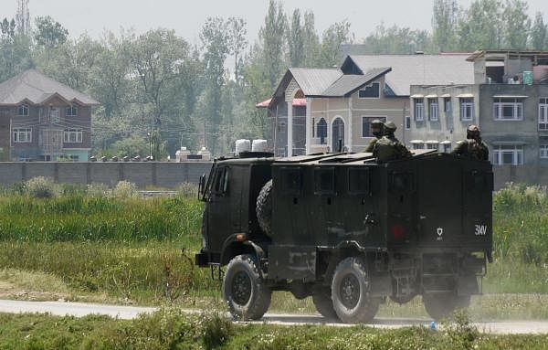 An Army vehicle arrives at the spot of encounter with militants at Pampore in Pulwama District of South Kashmir. Credits: PTI Photo