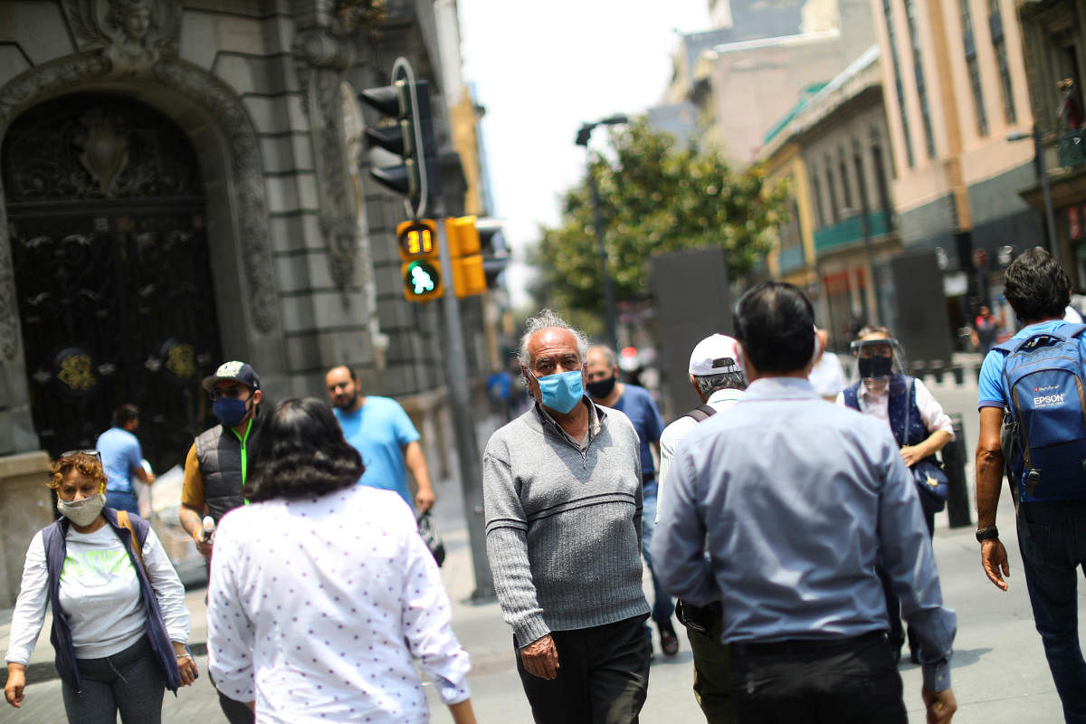 People walk on a street during the start of gradual reopening of commercial activities in downtown Mexico City, as the coronavirus disease (COVID-19) outbreak continues, Mexico June 30, 2020. Credit/Reuters Photo