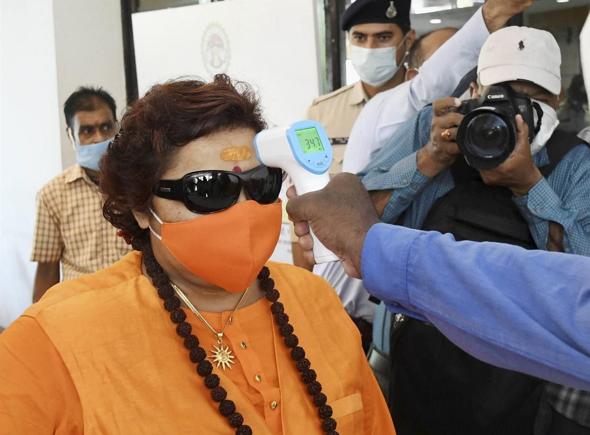 BJP MP Pragya Singh Thakur undergoes thermal screening during a flagging off ceremony as part of 'Kill Corona' campaign, in Bhopal. PTI