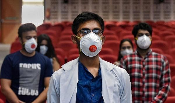 Doctors pay two-minute silent tribute to frontline workers who lost their lives in the fight against the coronavirus pandemic, during COVID Warriors in White Coat event on National Doctor's Day, at Lady Hardinge Hospital in New Delhi, Wednesday, July 1, 2020. Credit: PTI Photo