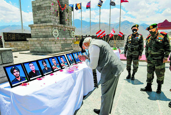 PM Narendra Modi pays tribute to the martyrs at a memorial, during his visit to a forward location in Nimu in Ladakh. Credit: PTI Photo