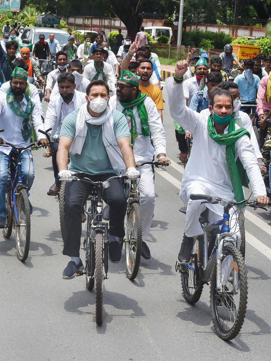 : Rashtriya Janata Dal leaders Tejaswi Yadav and Tej Partap Yadav with party workers ride cycles during a protest against price hike of petrol and diesel (PTI Photo)
