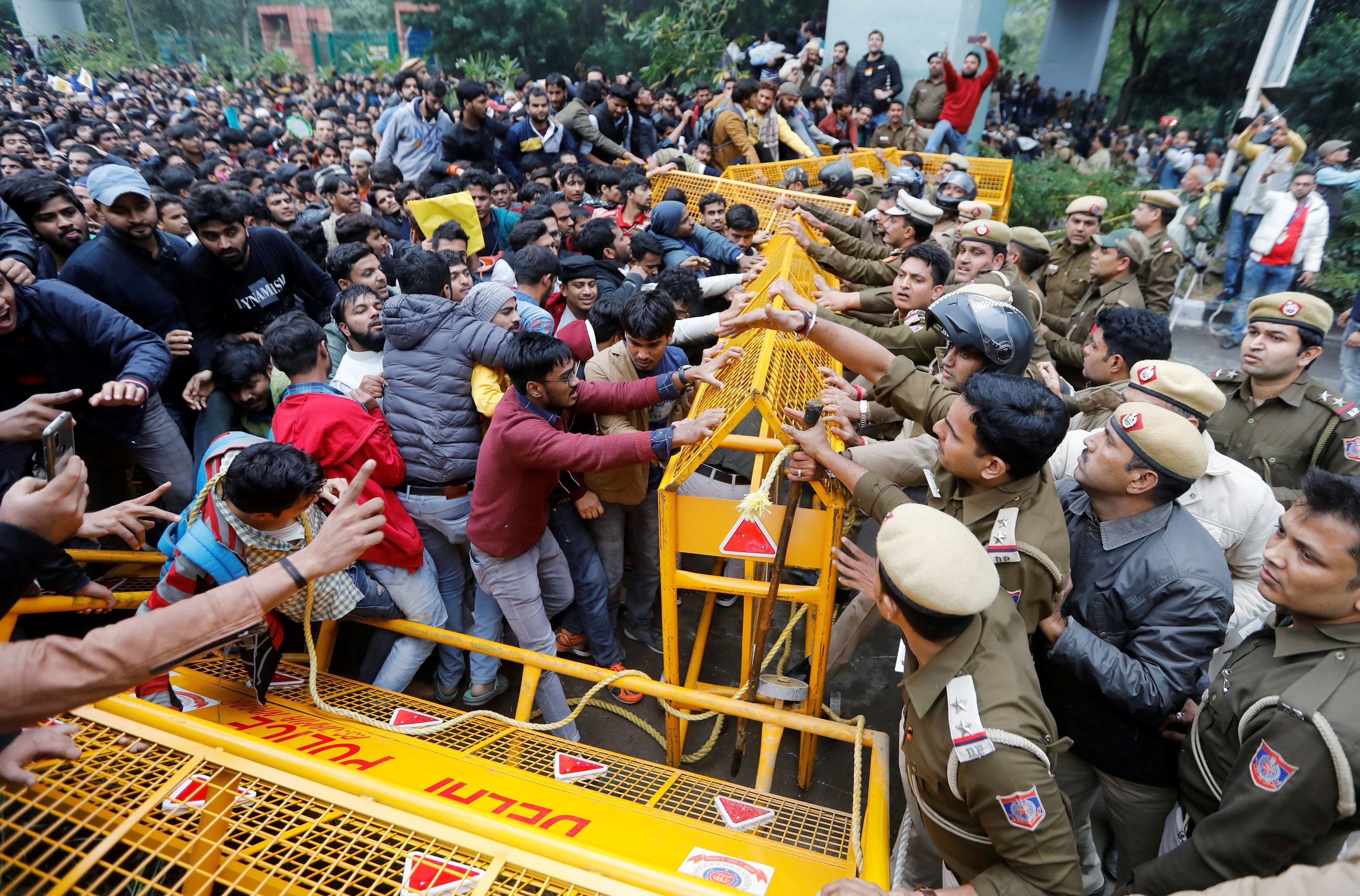 Police and protestors scuffle outside the Jamia Millia Islamia University during a protest against the Citizenship Amendment Bill, a bill that seeks to give citizenship to religious minorities persecuted in neighbouring Muslim countries, in New Delhi, India, December 13, 2019. Credit: REUTERS