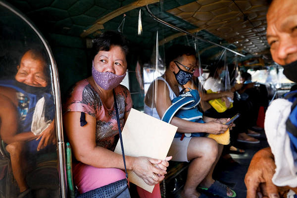 Passengers wearing masks for protection against the coronavirus disease. Credit: Reuters
