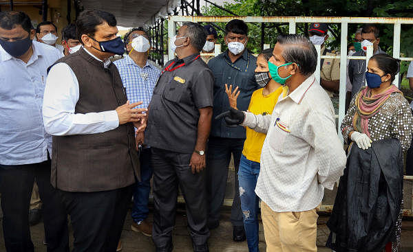 Former CM and senior BJP leader Devendra Fadnavis interacts with the relatives of patients during his visit to a dedicated Covid-19 hospital and quarantine centre, in Thane, Monday, July 6, 2020. Credit: PTI Photo