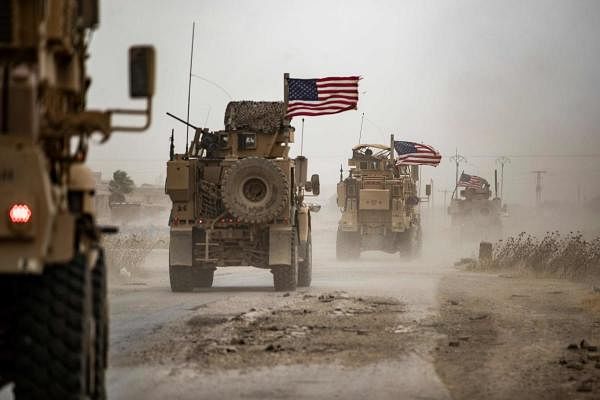 US military vehicles drive in the vicinity of an oil field in Rumaylan (Rmeilan) amid a sandstorm in Syria's kurdish-controlled northeastern Hasakeh province on July 1, 2020. Credits: AFP Photo