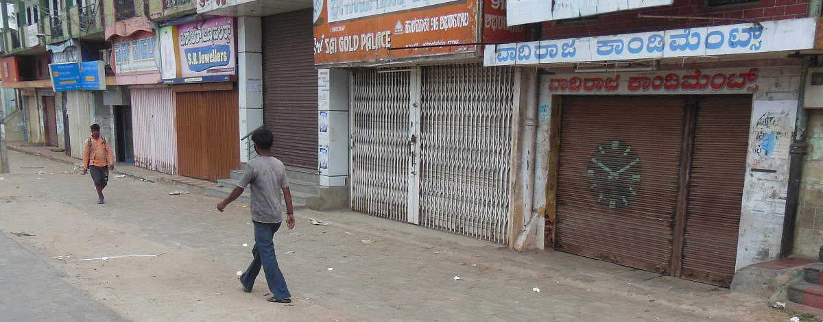 Shops closed in Channarayapatna, Hassan district, which implemented self-lockdown for 14 days from Monday. The shopkeepers have decided to close the shops after 11.30 am. DH PHOTO