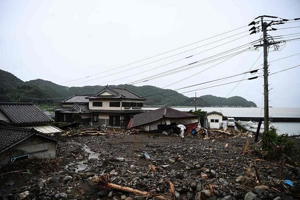A man walks in a landslide site caused by heavy rain in Tsunagi, Kumamoto prefecture. Credit: AFP